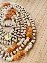 Load image into Gallery viewer, orange cream dark coffee brown waistbeads in a circle on light color wood surface
